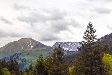Fototapeta premium Tyrol Austria alpine mountain and hill landscape panorama cloudy sky.