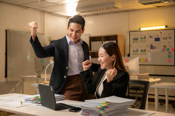 A man and a woman are standing in front of a white board with a lot of numbers o