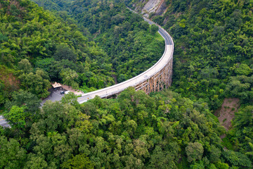 Top view Aerial photo from flying drone over The highest bridge pier Phor Khun Pha Muang Bridge (Huai Tong at Phetchaboon Thailand.Bridge over the jungle.Bridge over mountain and green forest