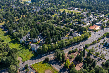 Aerial drone picture of a beautiful residential area in Cedar Mill, Portland, OR, captured at morning. Picture shows lush green courtyards, parking lots and housing buildings	
