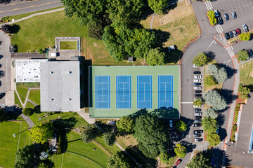 High resolution aerial drone picture of outdoor tennis courts and green fields near a high school in Cedar Mill, Portland, Oregon, captured on a clear summer day	
