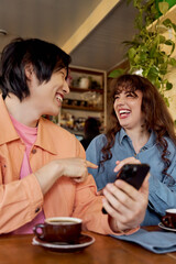 Friends share joyful moments in a cozy cafe, celebrating diversity and connection