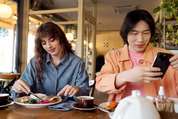 Friends enjoying a delightful brunch in a cozy multicultural cafe setting