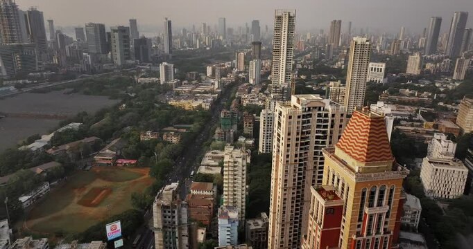 Golden Horizons: Captivating Evening Aerial of Mumbai's Skyline at Sunset, Over Lower Parel, Mahalaxmi, and Currey Road. High-rise buildings. High-rise residential buildings in an Indian city.