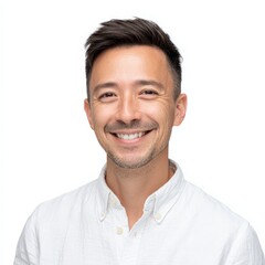 Smiling man looks directly at camera in studio shot. Happy, positive attitude, friendly demeanor, business headshot.