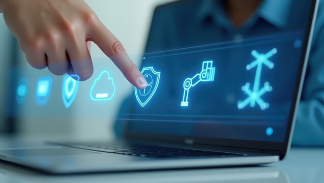 A hand interacts with a laptop screen displaying industrial control system icons.