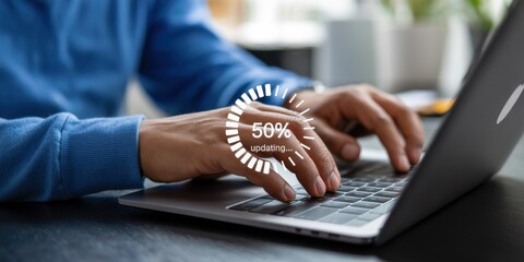Close-up of hands typing on a laptop with an update progress indicator.