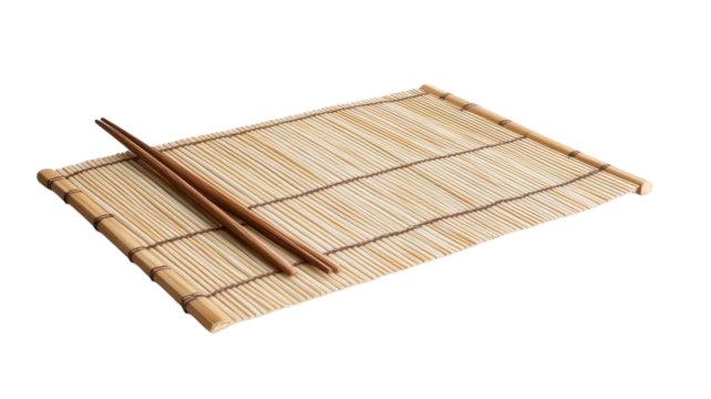 A bamboo sushi mat and chopsticks are set up for an upcoming sushi-making session in a minimal space