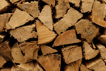 Close-up of stacked firewood, perfect for winter warmth and cozy ambiance. Ideal for blogs,...