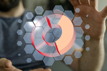 Stock photo of a man interacting with a futuristic 3D pie chart interface.