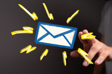 A hand reaches towards a bright email icon, symbolizing new messages or notifications.