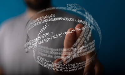 A hand interacts with a futuristic digital sphere showing lines of code, representing the internet.
