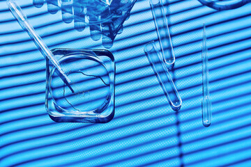 Sample being pipetted into petri dish and test tube for analysis in laboratory. Science research, medical trial  and development concept.