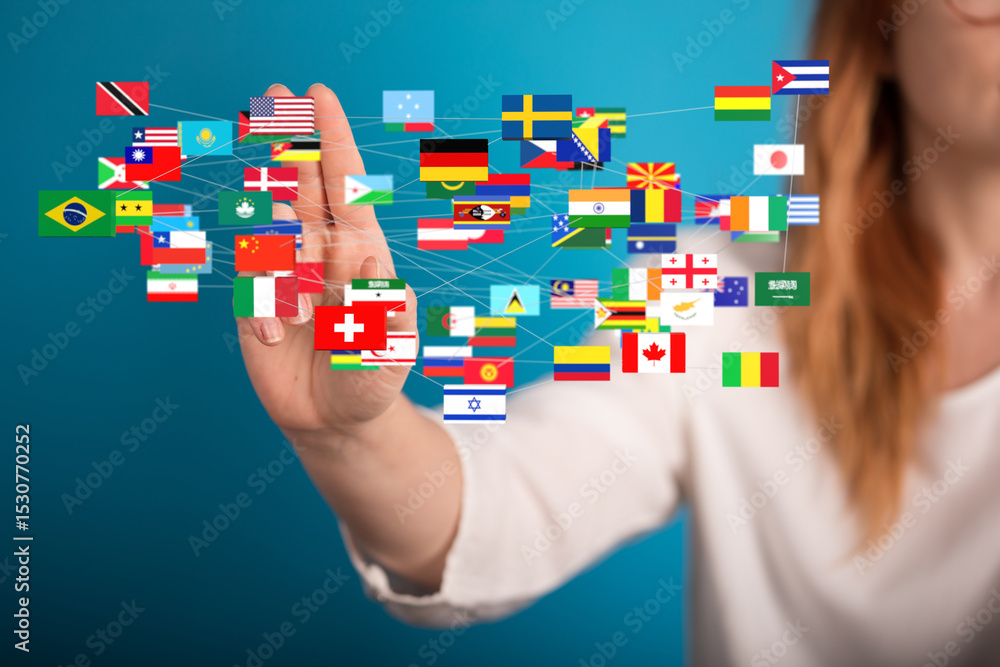 Aufkleber Image of a woman's hand interacting with a network of interconnected world flags, representing global communication and connection.