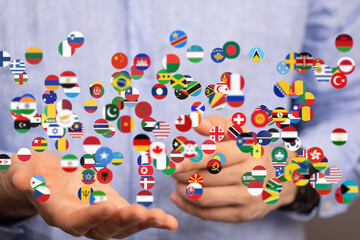 Image of hands holding various national flags, representing global connection and international...