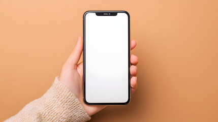 A hand holds a smartphone with a blank white screen against a peach background.