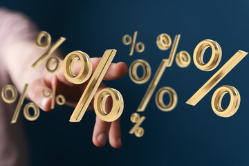 High-quality stock photo of a hand reaching for 3D golden percentage symbols. Ideal for finance,...