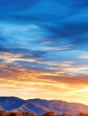 Obraz premium Vibrant sunset over rolling mountains with dramatic skies and tranquil atmosphere