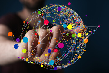 Abstract image of a hand interacting with a colorful network sphere.  Represents connection,...