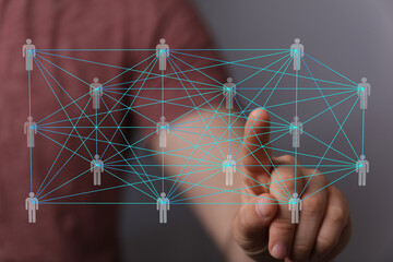 Hand interacting with a digital network of interconnected people, representing global communication...