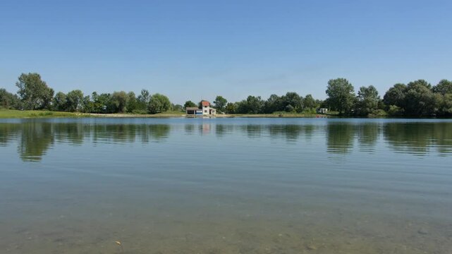 Serene view of Ivanovacka ada in Serbia showcasing calm waters and lush greenery