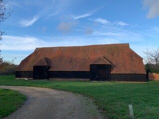 Fototapeta premium old farm barn with large tile roof