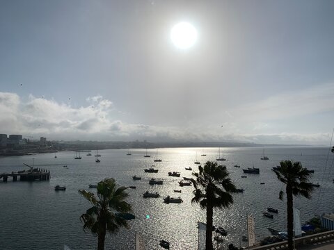sunset view across the coast with little boats moored