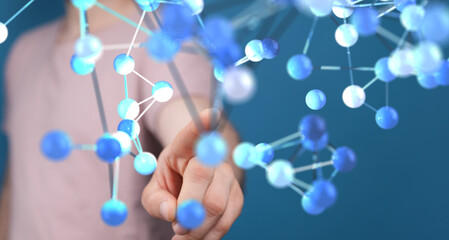 Close-up of a hand interacting with a holographic molecular model, representing science,...