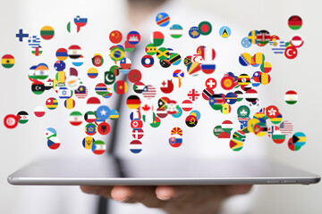 Image of diverse flags on a tablet, representing global networking and international business.