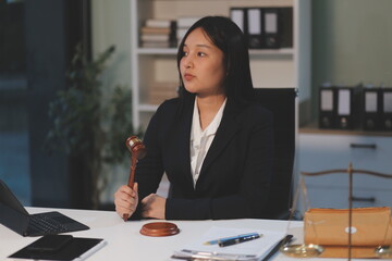 Judge gavel with Justice lawyers having team meeting at law firm background. Concepts of Law and...