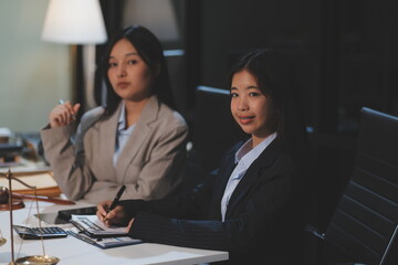 Judge gavel with Justice lawyers having team meeting at law firm background. Concepts of Law and Legal services.