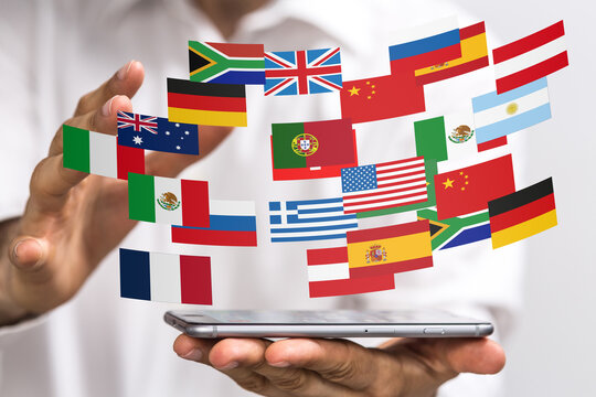 Person holding smartphone displaying flags of various countries, symbolizing global communication and international business.