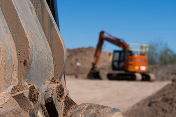 A depth of field blurred shot of a exavator vehicle in the background