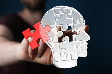 Abstract image depicting a person completing a jigsaw puzzle shaped like a head, symbolizing...