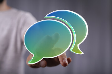Abstract image of person interacting with digital speech bubbles.  Perfect for communication, collaboration, and conversation concepts.