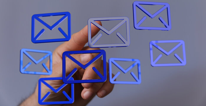Abstract image of a hand interacting with email icons.  Perfect for digital communication, technology, and networking concepts.