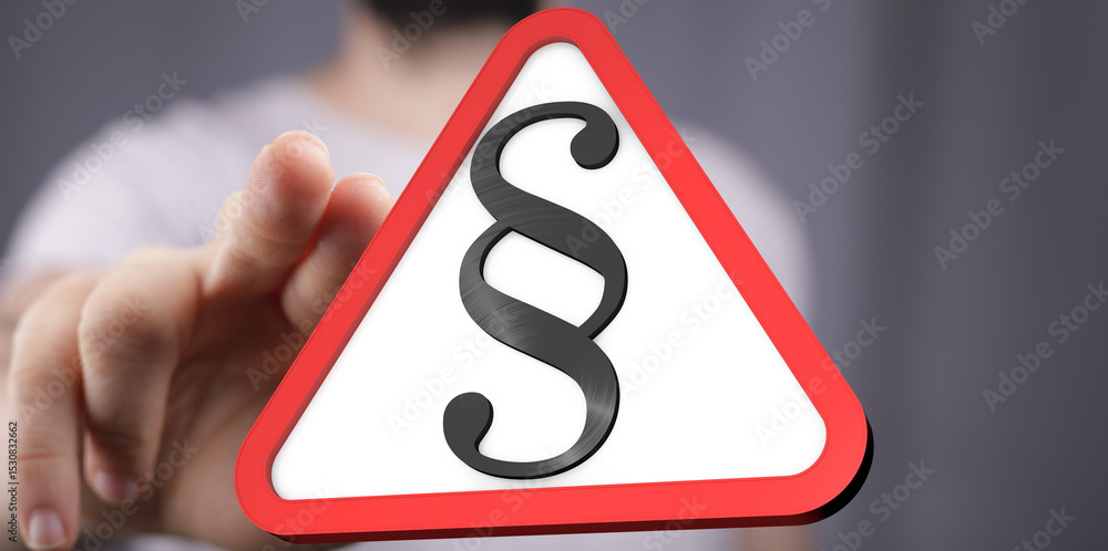 Poster hand pointing at a red triangle warning sign with a paragraph symbol. legal concept.