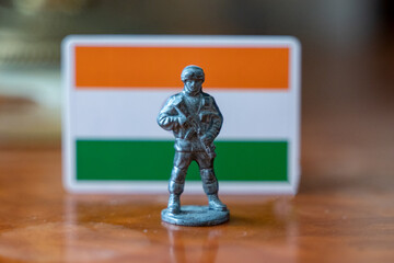 A tin soldier on the background of the Indian flag. India Pakistan military conflict