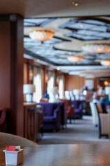 Cozy living room atmosphere inside cafe café coffee shop bar lounge bistro onboard luxury cruiseship cruise ship liner in contemporary Art Deco interior design