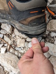 Old worn hiking boots with detached soles after challenging mountain hike in alpine terrain.