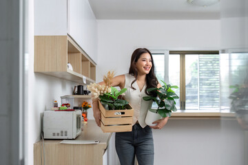 Moving Home: Woman with Plants in Kitchen