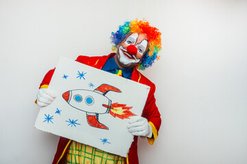 Clown holding cardboard with drawing