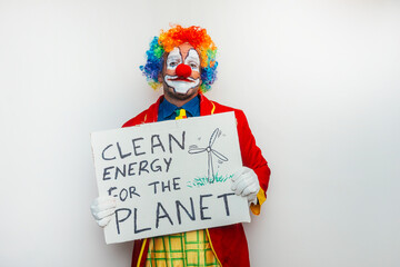 Clown holding sign about clean energy