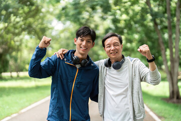 Father and Son Wellness Bonding. Celebrating fitness achievements together in nature.