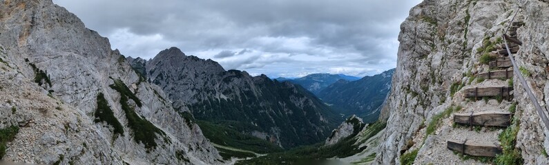 Panoramic view of Logarska dolina valley with peaks of Slovenian Alps covered by passing clouds.