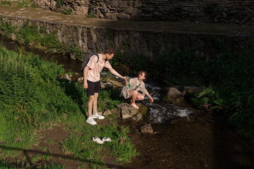 A couple watches the Leghvtakhevi waterfall in the Tbilisi Old Town canyon in abanotubani, enjoying a peaceful moment surrounded by nature