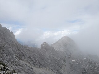 Panoramic view of Logarska dolina valley with peaks of Slovenian Alps covered by passing clouds.