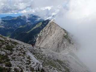 Panoramic view of Logarska dolina valley with peaks of Slovenian Alps covered by passing clouds.