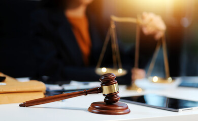 Judge gavel with Justice lawyers having team meeting at law firm background. Concepts of Law and Legal services.