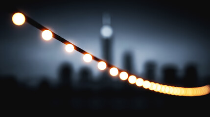 Warm string lights in soft cinematic focus with glowing city skyline and bokeh night background